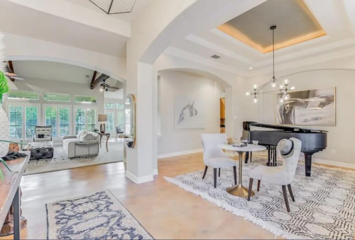 413 Breakaway Road Cedar Park, TX 78613 - Photo 6 of 21 Dining area featuring suspended lighting, a tray ceiling, ceiling fan, arched walkways, and concrete flooring