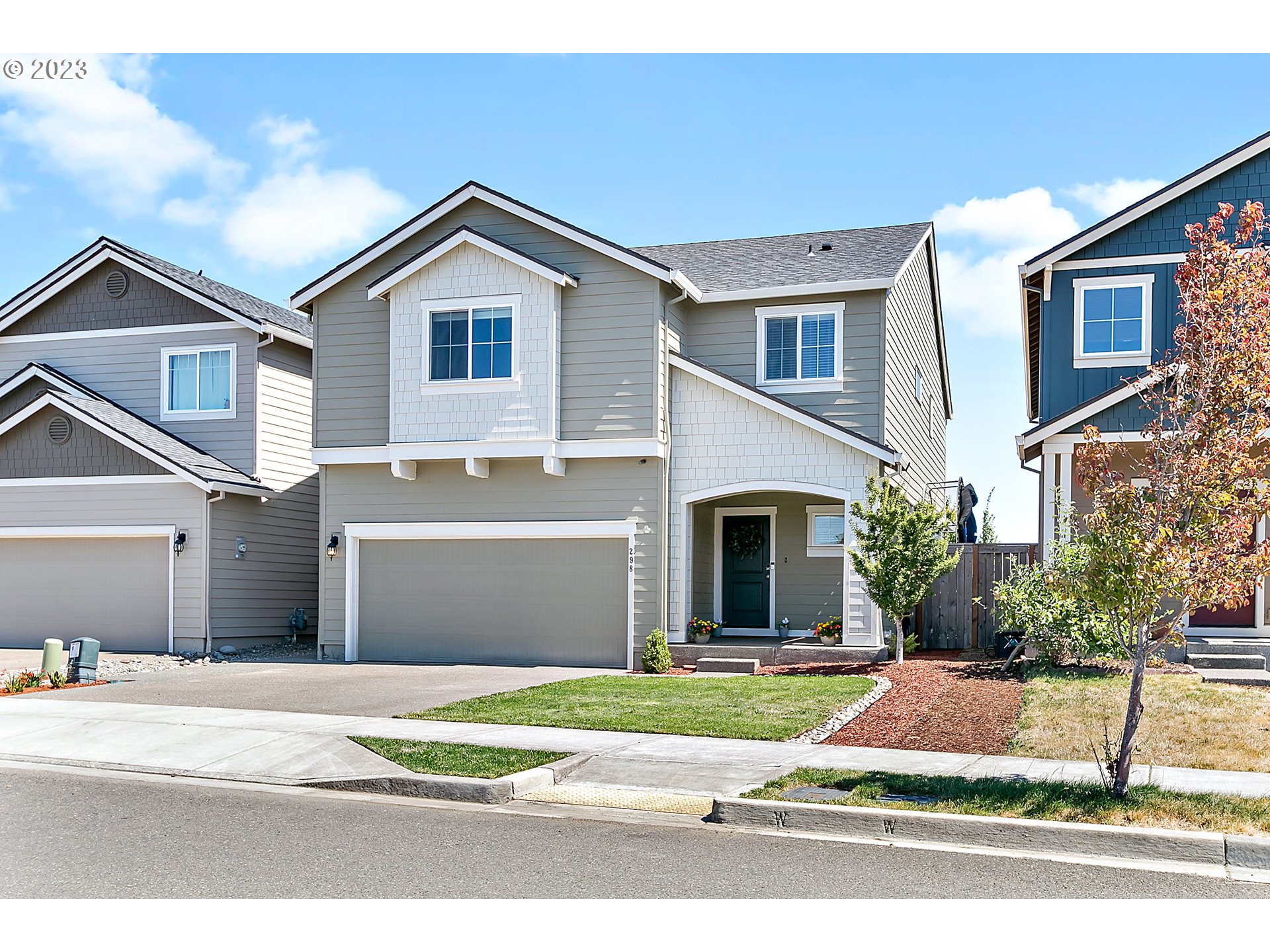 298 North 34th Court Ridgefield, WA 98642 - Photo 1 of 36 a front view of a house with a yard and garage