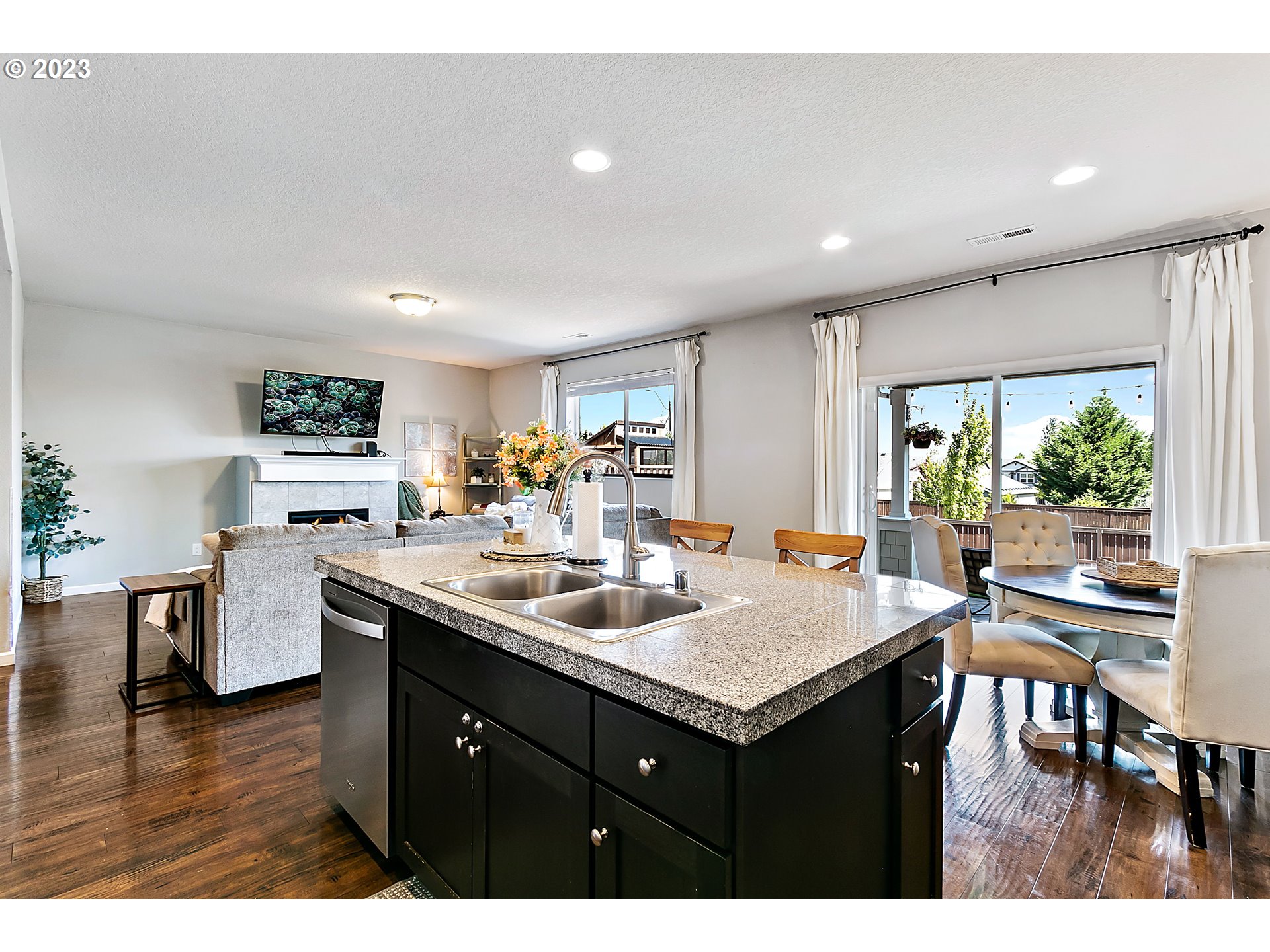 298 North 34th Court Ridgefield, WA 98642 - Photo 13 of 36 a kitchen with a stove a sink a dining table and chairs