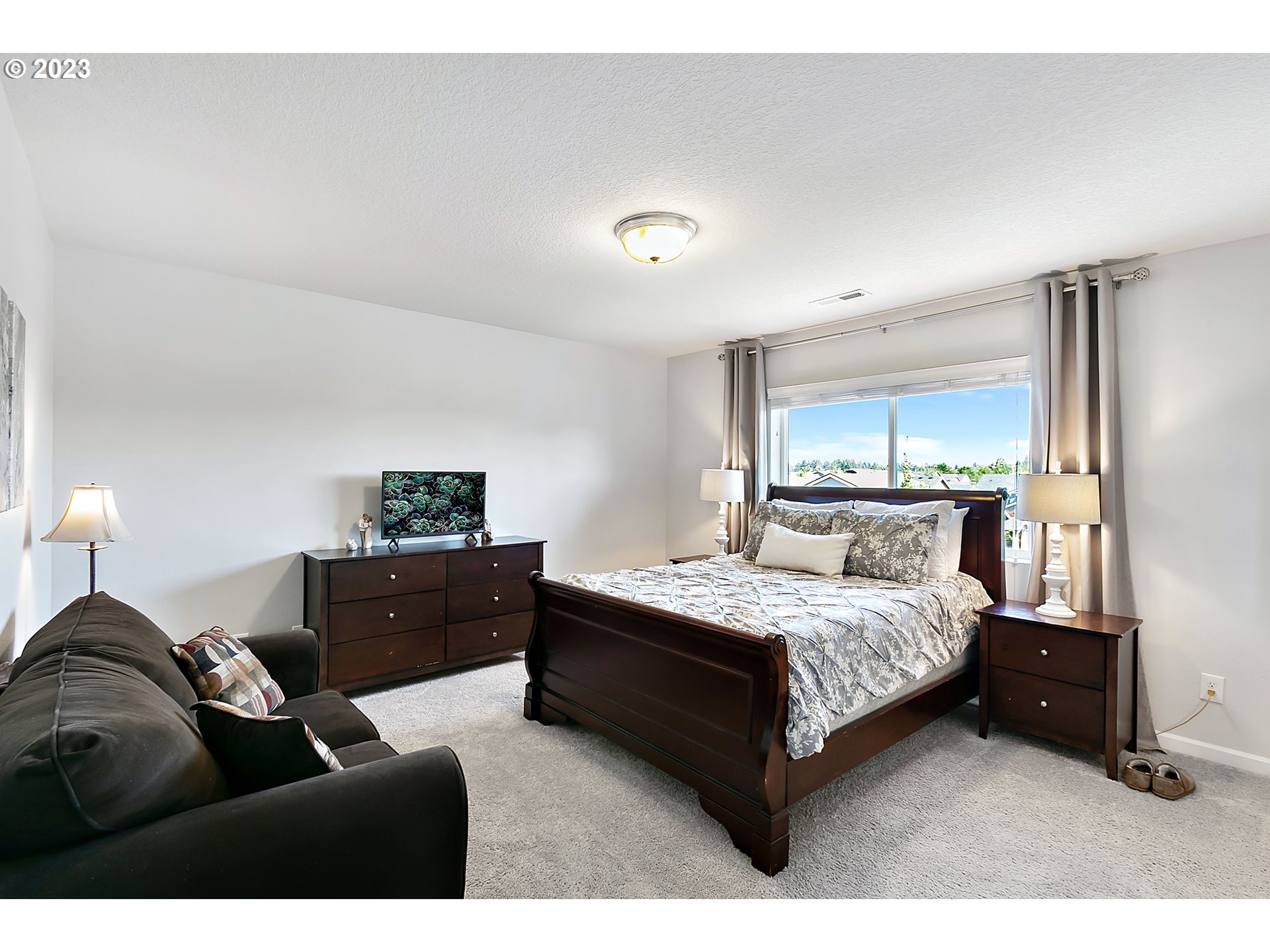 298 North 34th Court Ridgefield, WA 98642 - Photo 17 of 36 a bedroom with a bed window and a night stand