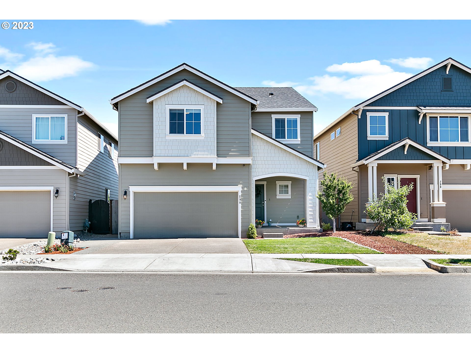298 North 34th Court Ridgefield, WA 98642 - Photo 2 of 36 a front view of a house with a yard and garage