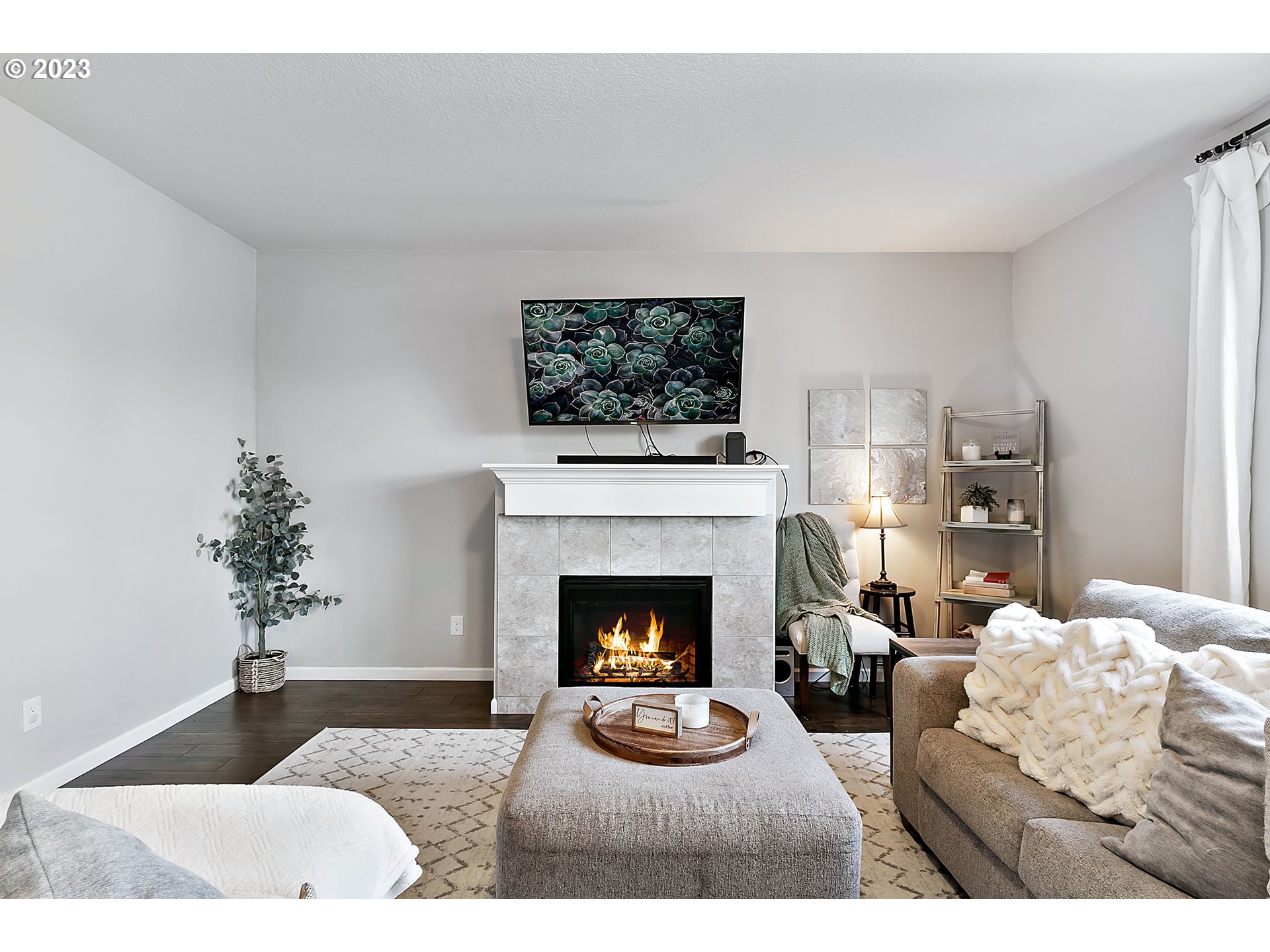 298 North 34th Court Ridgefield, WA 98642 - Photo 7 of 36 a living room with furniture a fireplace and a flat screen tv