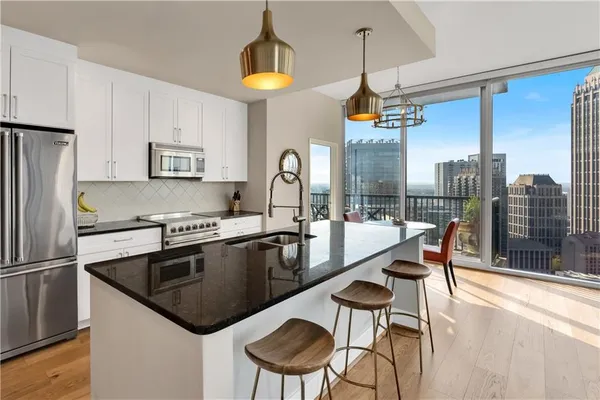 a kitchen with a stove a sink and a refrigerator