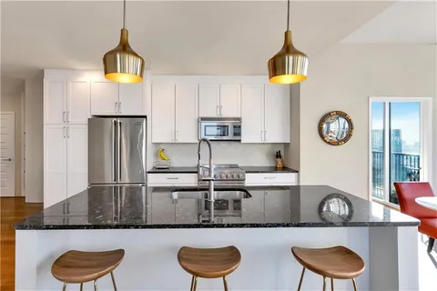 a kitchen with kitchen island a counter space a sink and a stove