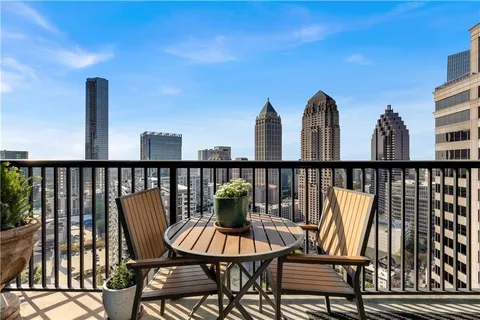 a view of a balcony with chairs