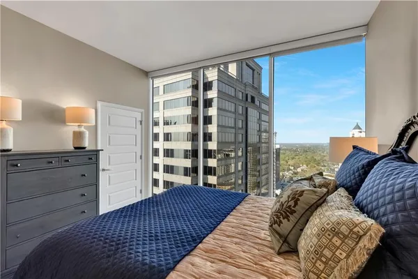 a bedroom with a bed and walk in closet with bedroom