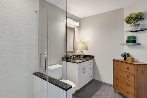 a bathroom with a granite countertop sink a vanity and a mirror