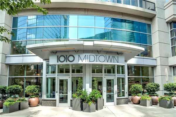 a view of a building with a potted plant sitting area