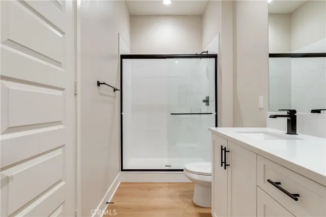 a bathroom with a granite countertop sink toilet and shower