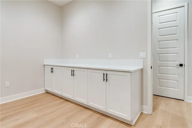 a view of a kitchen with dishwasher and wooden floor