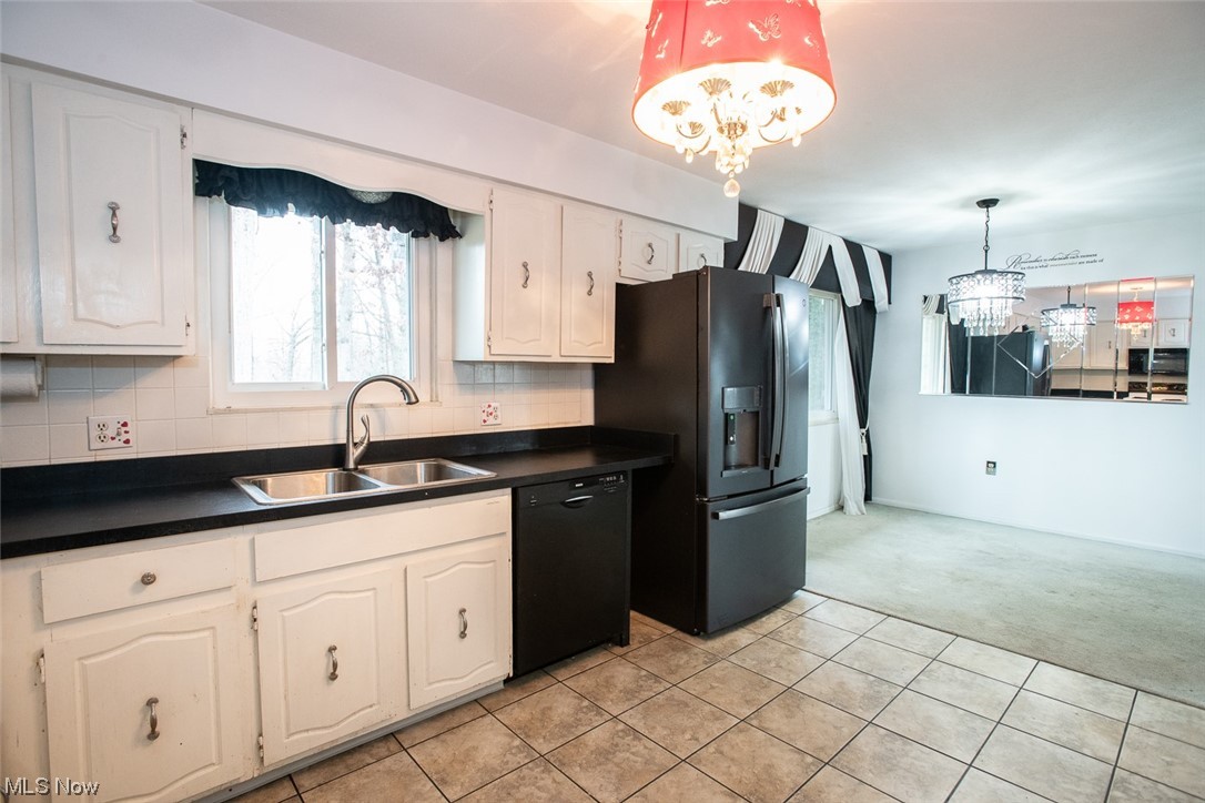 14358 Prospect Road Strongsville, OH 44149 - Photo 6 of 35 Kitchen with sink, a chandelier, tasteful backsplash, decorative light fixtures, and black appliances