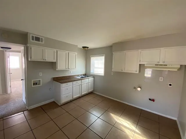 a kitchen with stainless steel appliances a sink stove and cabinets