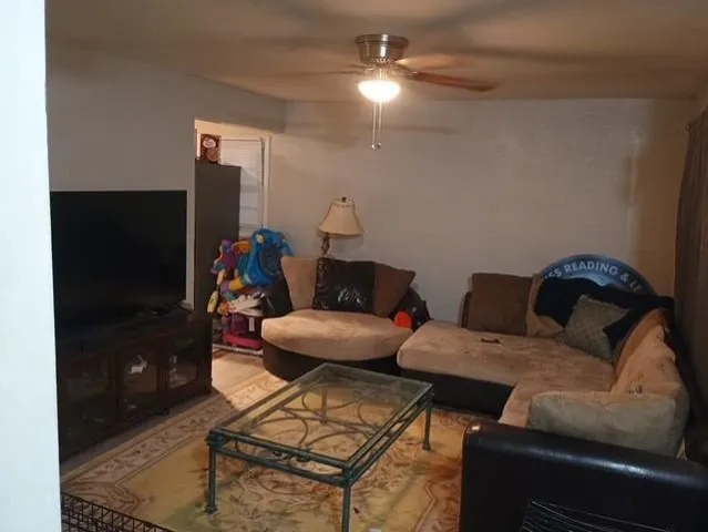 a living room with furniture and a flat screen tv