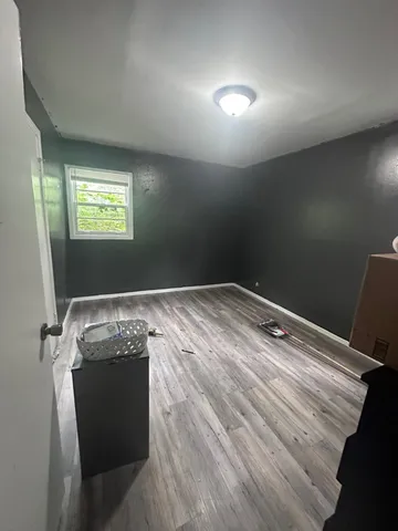 an empty room with wooden floor