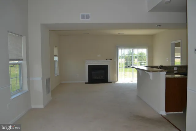a view of a kitchen with a sink and a fireplace