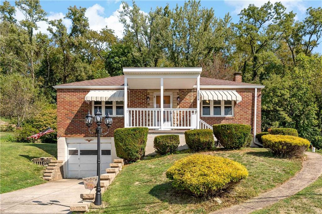 12219 Herold Drive Irwin, PA 15642 - Photo 1 of 28 front view of a house with a yard