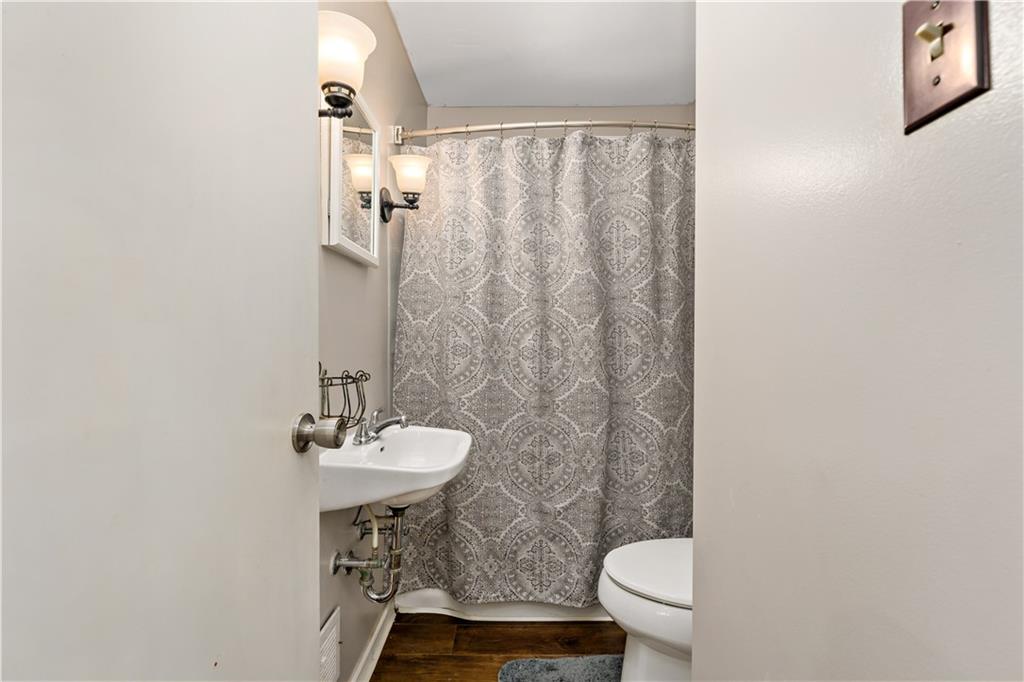 12219 Herold Drive Irwin, PA 15642 - Photo 11 of 28 a bathroom with a sink a toilet and a mirror