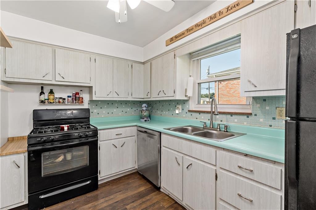 12219 Herold Drive Irwin, PA 15642 - Photo 9 of 28 a kitchen with a sink stove top oven and cabinets