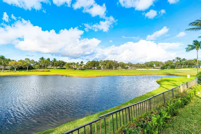 a room with lots of white furniture and glass door