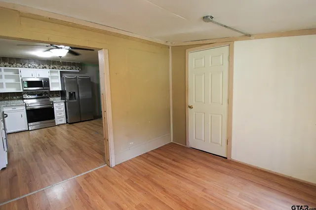 a view of a kitchen with a sink and a refrigerator