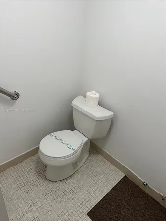 a white toilet sitting next to a bathroom sink