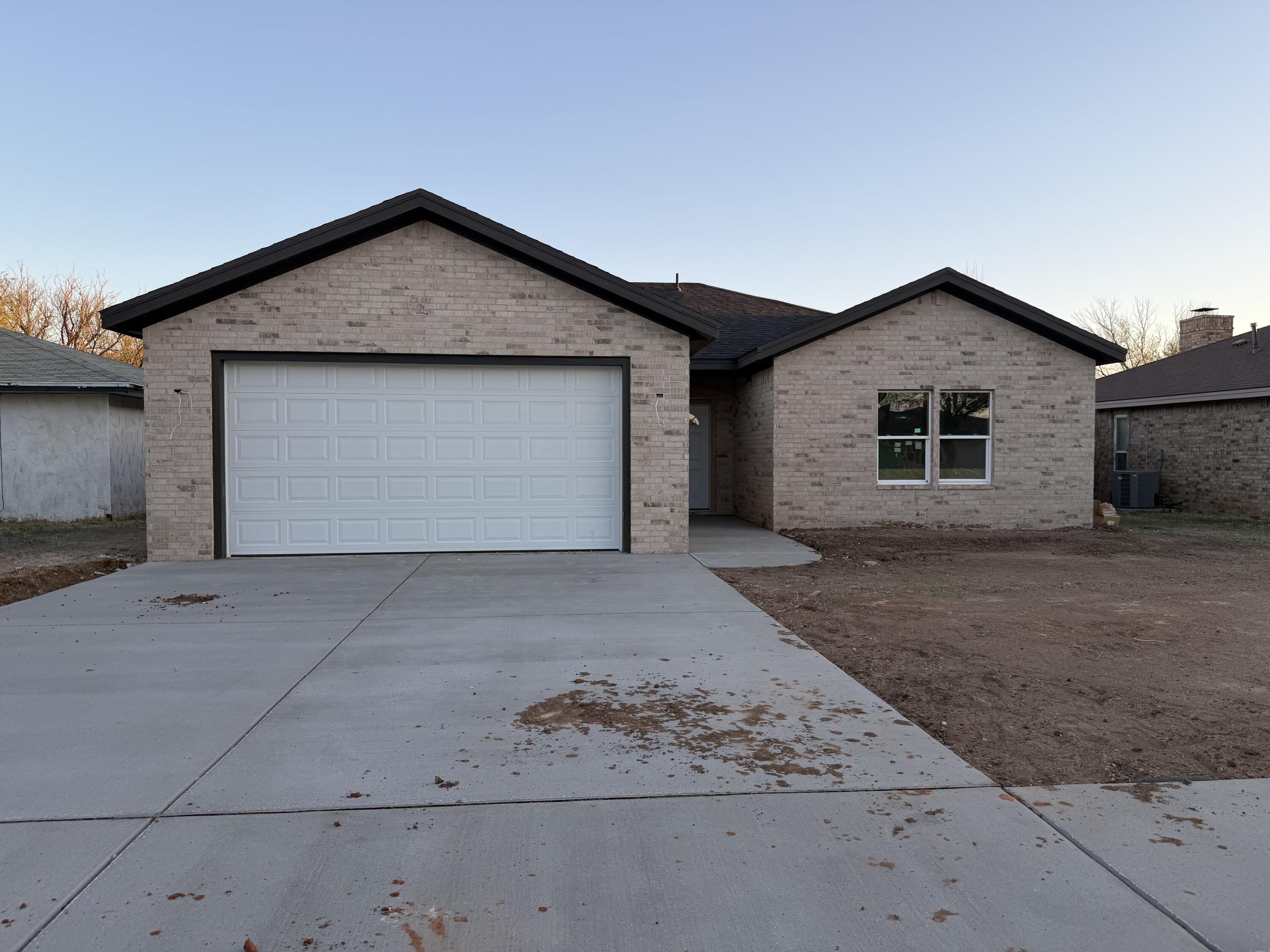 6412 38th Street Lubbock, TX 79407 - Photo 12 of 20 a front view of a house with a yard and garage