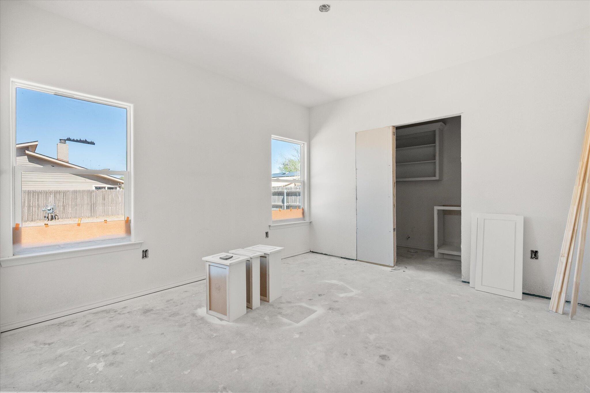 6412 38th Street Lubbock, TX 79407 - Photo 7 of 20 an empty room with windows and closet