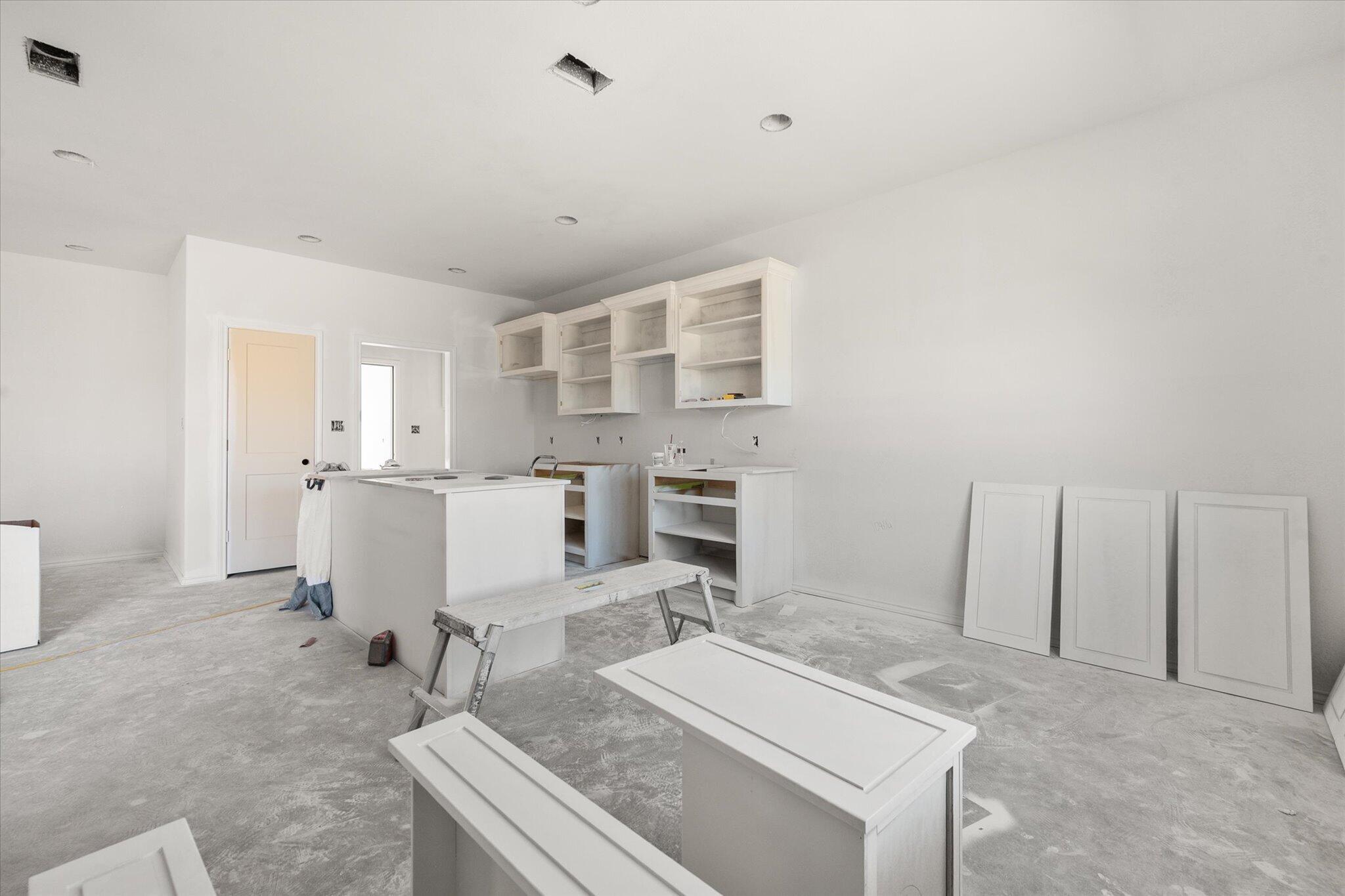 6412 38th Street Lubbock, TX 79407 - Photo 10 of 20 a living room with furniture a fireplace and kitchen view
