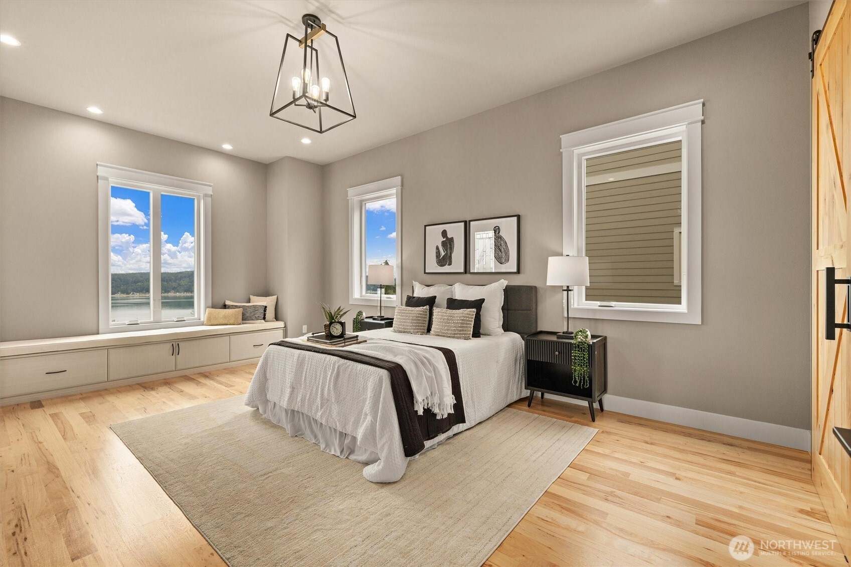 151 East Windy Ridge Lane Belfair, WA 98528 - Photo 17 of 40 a spacious bedroom with a large bed and a window