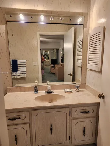 a bathroom with a sink and a mirror