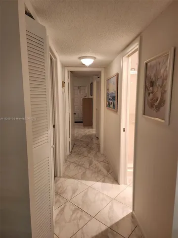 a view of a hallway with wooden shelves