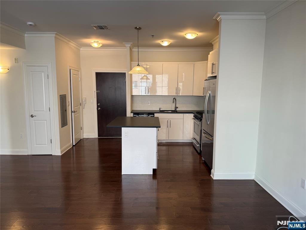 2001 Hudson Terrace, Unit 302 Fort Lee, NJ 07024 - Photo 1 of 16 an open kitchen with wooden floor and a refrigerator