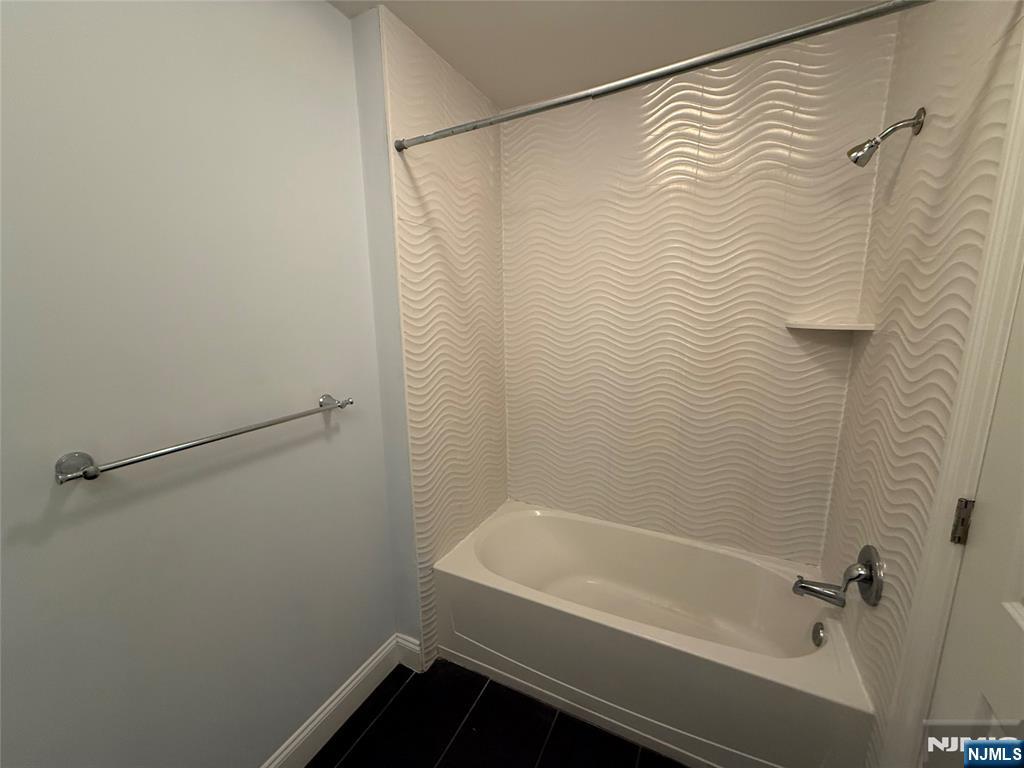 2001 Hudson Terrace, Unit 302 Fort Lee, NJ 07024 - Photo 11 of 16 a bathroom with a bathtub and shower