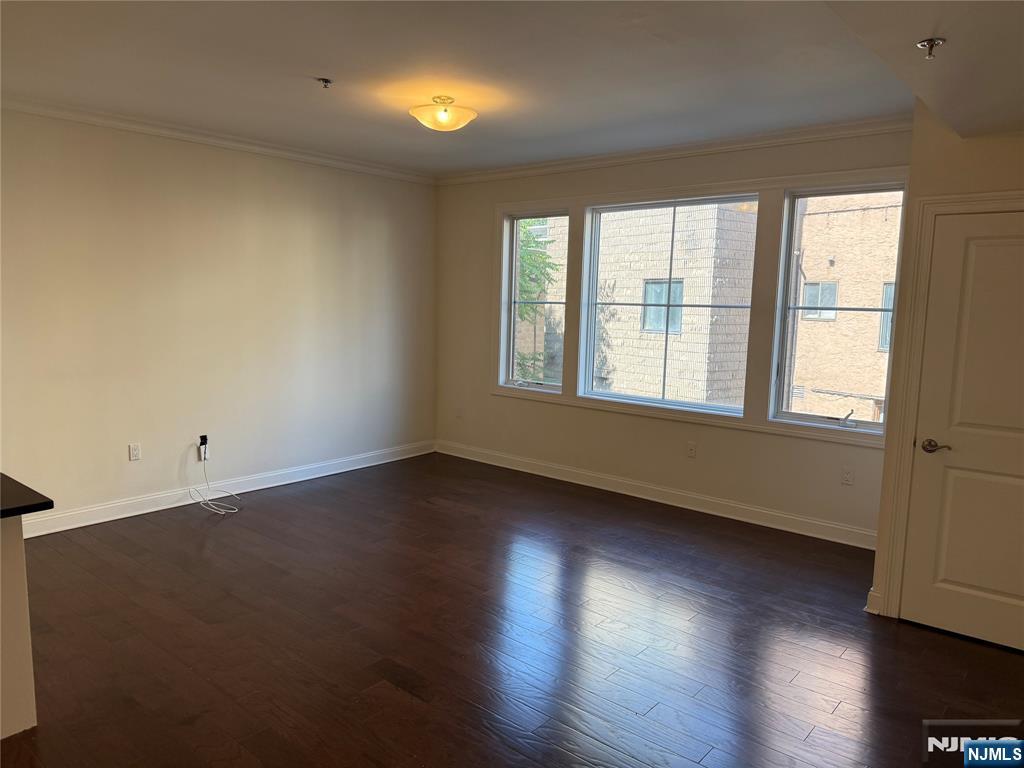 2001 Hudson Terrace, Unit 302 Fort Lee, NJ 07024 - Photo 4 of 16 an empty room with wooden floor and windows