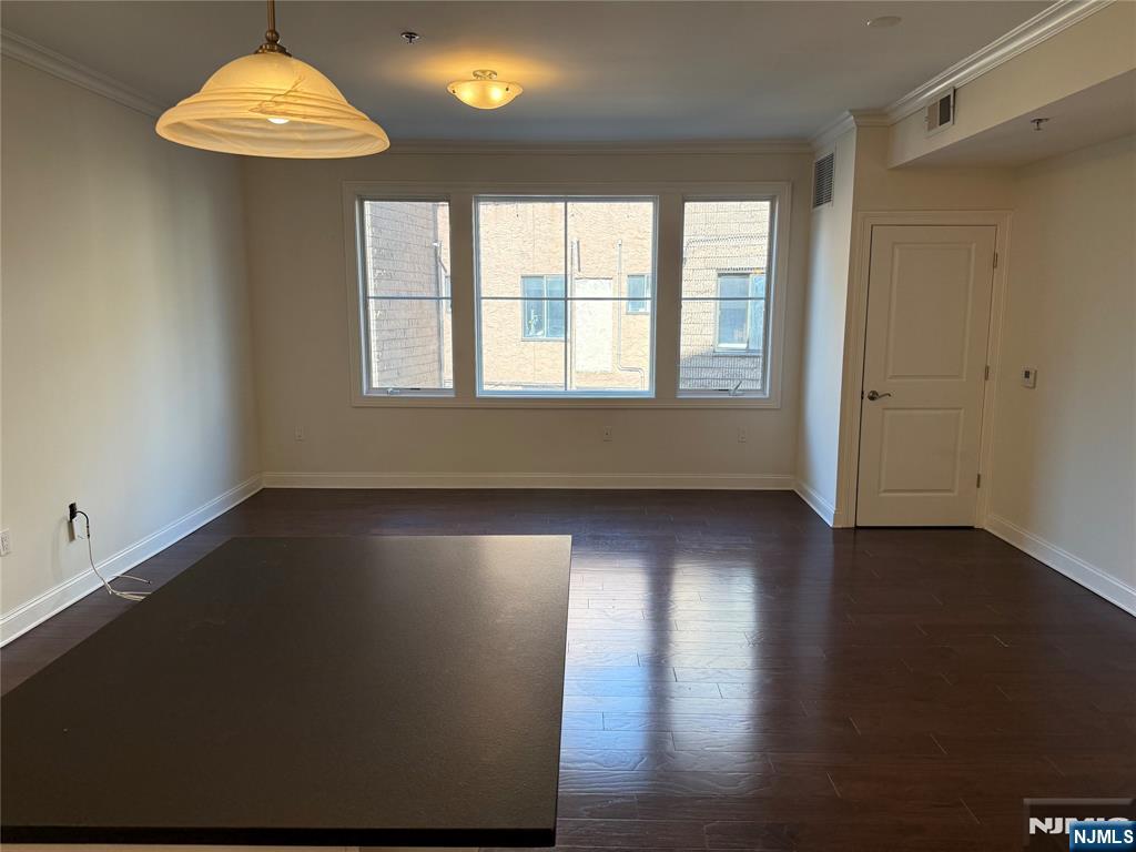 2001 Hudson Terrace, Unit 302 Fort Lee, NJ 07024 - Photo 5 of 16 an empty room with wooden floor and windows