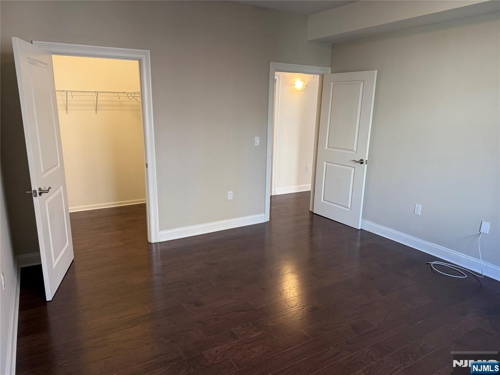 2001 Hudson Terrace, Unit 302 Fort Lee, NJ 07024 - Photo 7 of 16 an empty room with wooden floor and a window