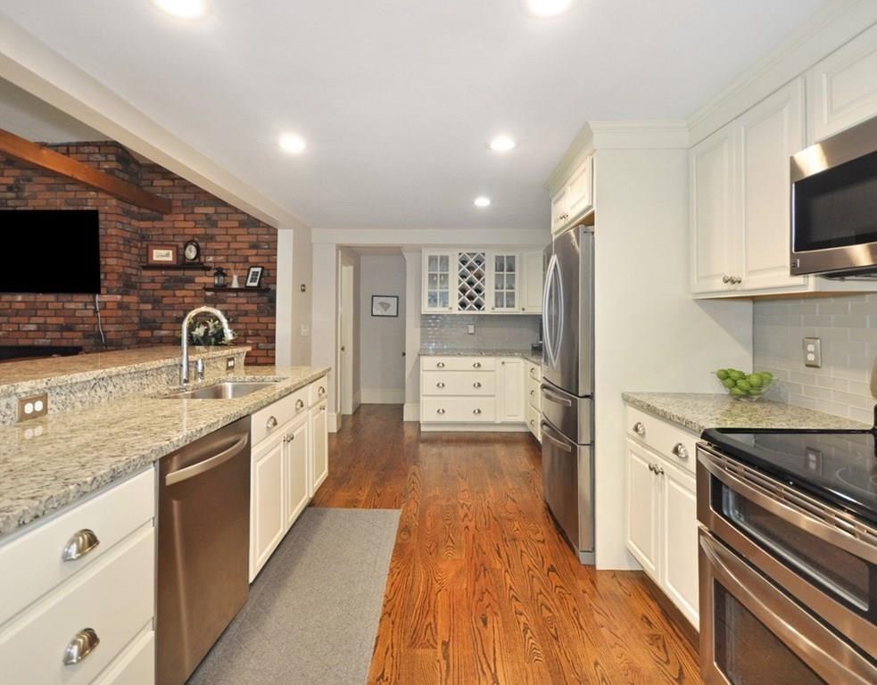 333 Depot Road Boxborough, MA 01719 - Photo 16 of 38 a kitchen with granite countertop a sink stove and refrigerator