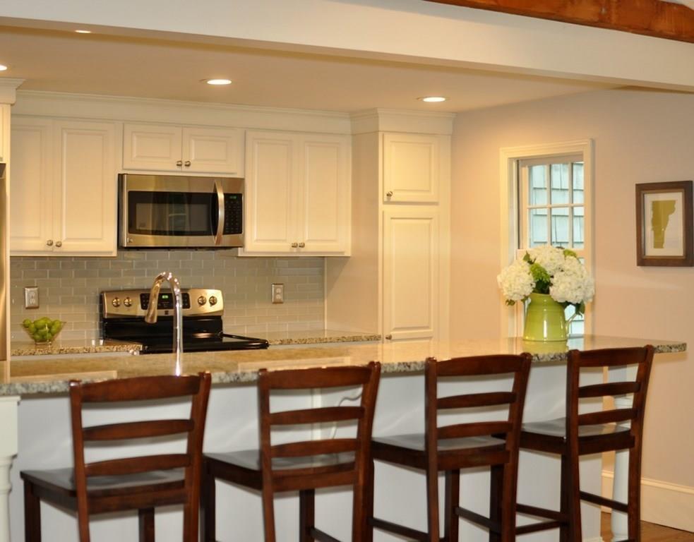 333 Depot Road Boxborough, MA 01719 - Photo 18 of 38 a kitchen with a table chairs microwave and cabinets