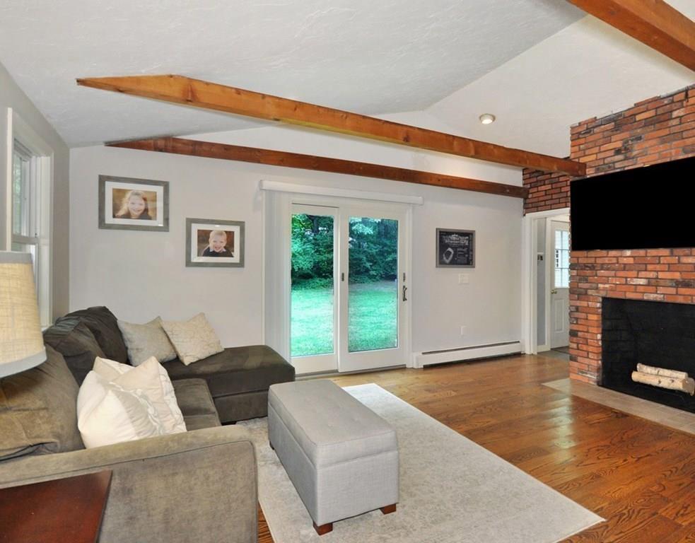 333 Depot Road Boxborough, MA 01719 - Photo 20 of 38 a living room with furniture a flat screen tv and a fireplace