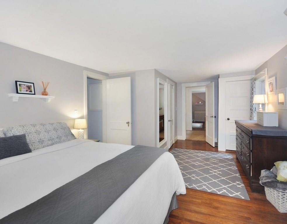 333 Depot Road Boxborough, MA 01719 - Photo 26 of 38 a bedroom with a large bed and wooden floor