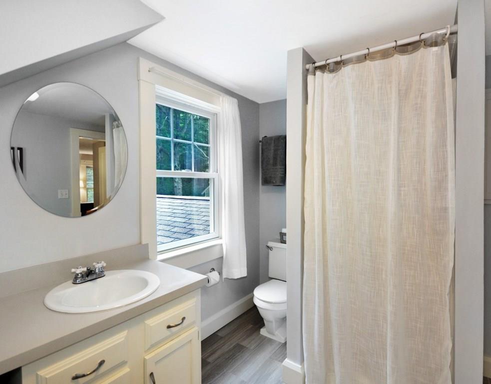 333 Depot Road Boxborough, MA 01719 - Photo 28 of 38 a bathroom with a toilet a sink and a mirror