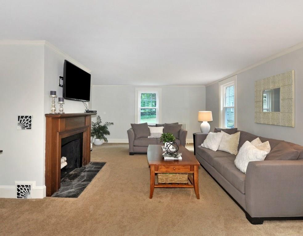 333 Depot Road Boxborough, MA 01719 - Photo 5 of 38 a living room with furniture a flat screen tv and a fireplace