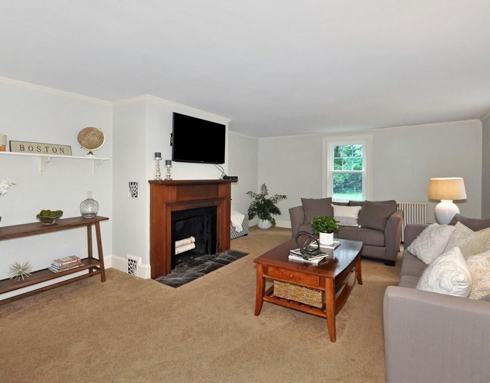 333 Depot Road Boxborough, MA 01719 - Photo 6 of 38 a living room with furniture a fireplace and a flat screen tv