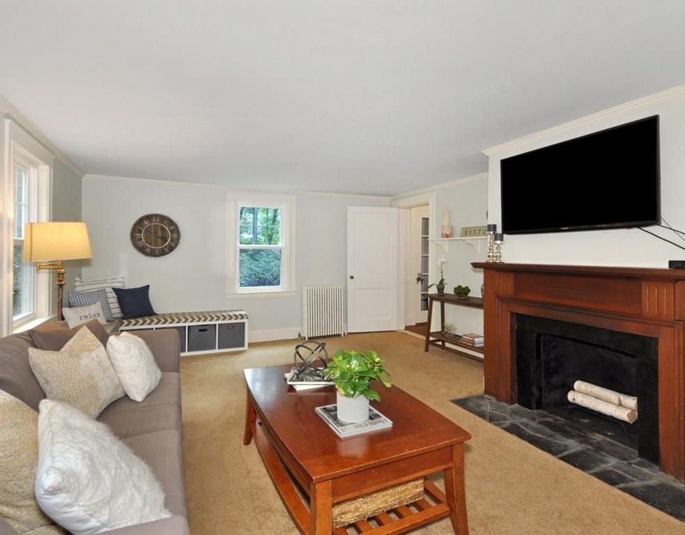 333 Depot Road Boxborough, MA 01719 - Photo 7 of 38 a living room with furniture a flat screen tv and a fireplace