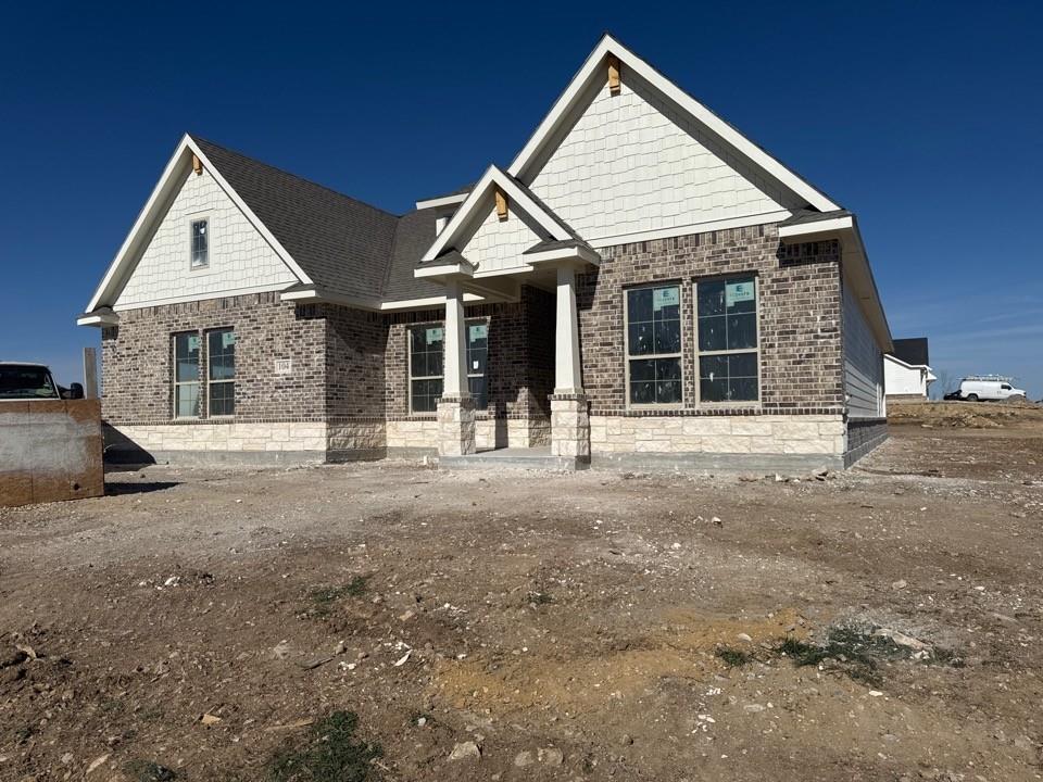 104 Snowy Owl Trail Rhome, TX 76078 - Photo 1 of 10 a front view of a house with a yard
