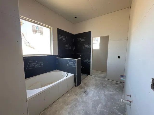 a bathroom with a bathtub and a sink