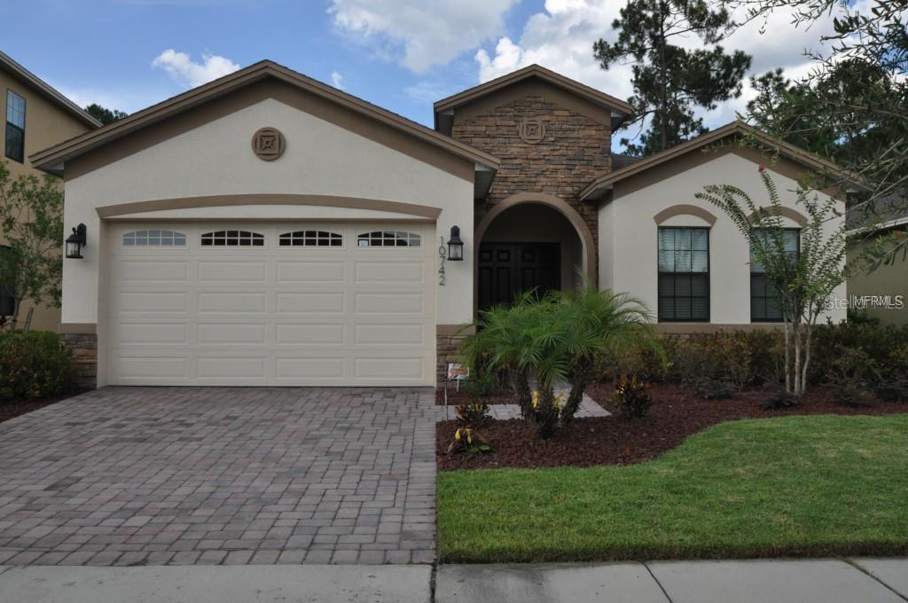 10742 Willow Ridge Loop Orlando, FL 32825 - Photo 1 of 1 a front view of a house with a yard