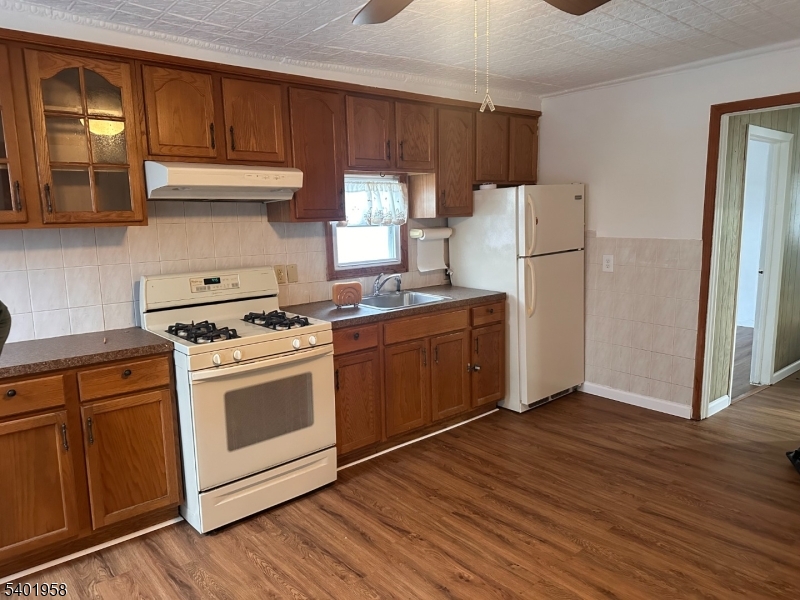 a kitchen with a stove a refrigerator and a sink