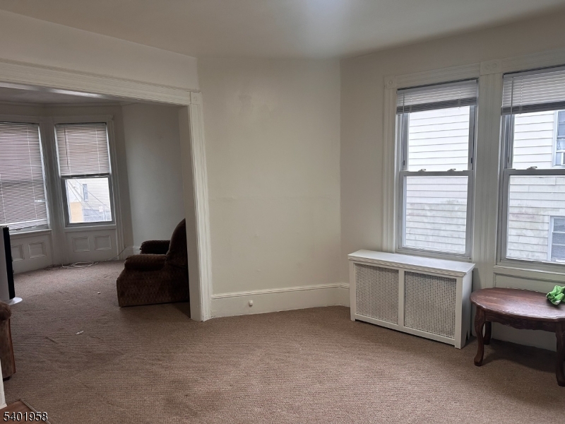 986 Madison Avenue Paterson, NJ 07501 - Photo 3 of 10 a living room with furniture and a window