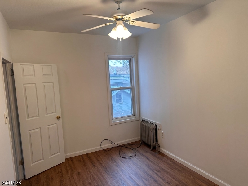 986 Madison Avenue Paterson, NJ 07501 - Photo 5 of 10 an empty room with windows and fan